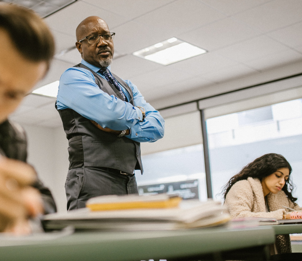 Photo by RODNAE Productions on Pexels A teacher supervising students during an exam